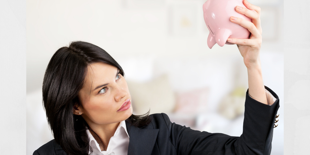 A lady looking at an empty piggybank