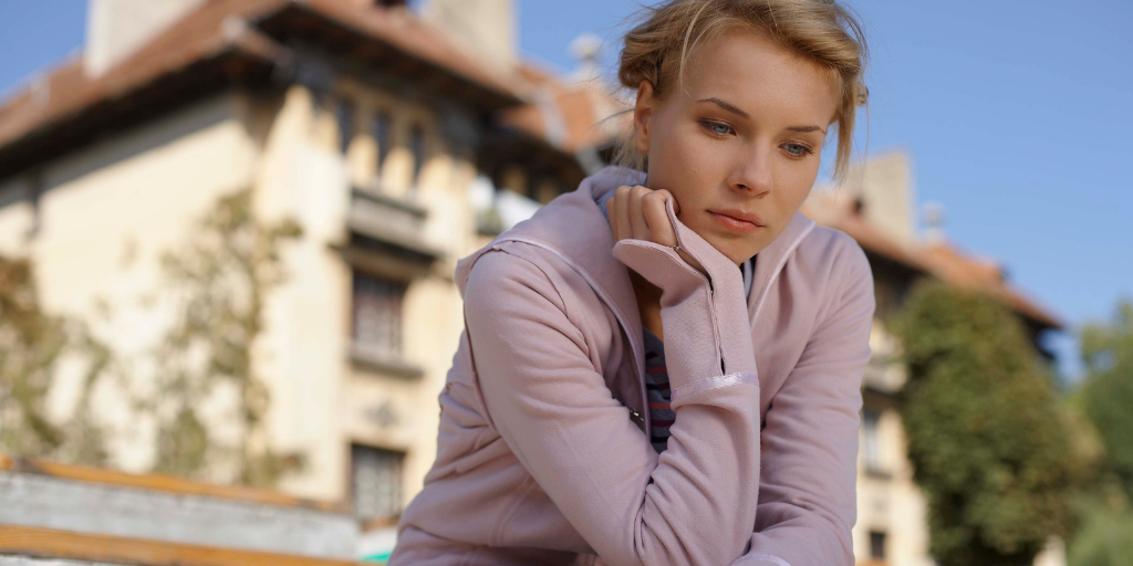 A woman under depression, sitting on steps