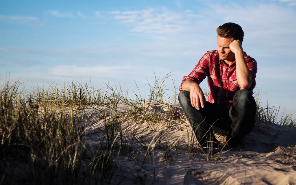 A man sitting on the floor thinking, what to do next