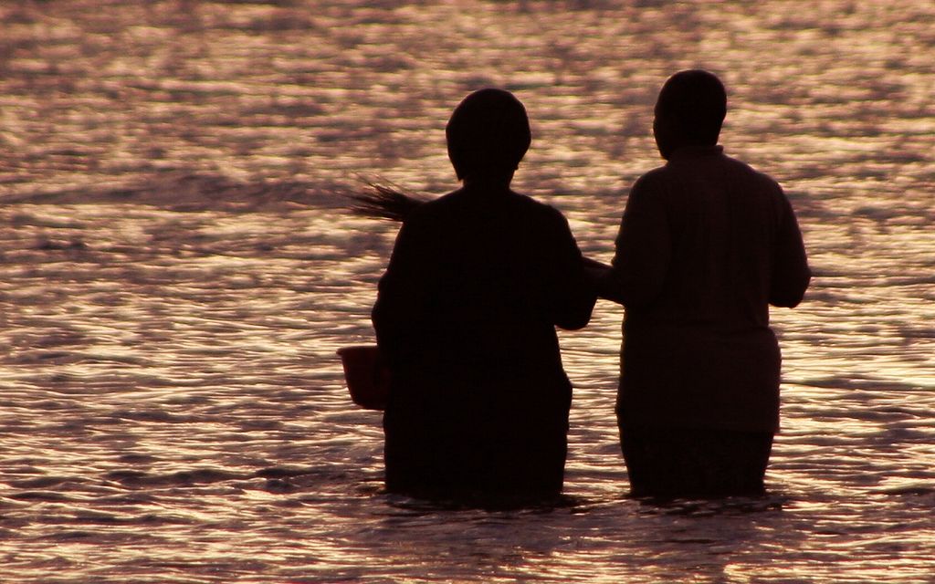 a person getting baptized in a river